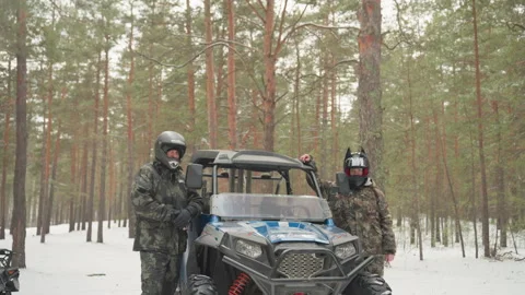 Snowy forest adventure. Two motorcyclists in snowy pine woods. Brightly clad Stock Footage 337822767