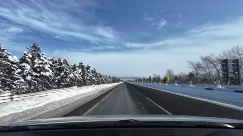 Snowy highway with pine trees and pedestrian bridge Hokkaido Stockbeeldmateriaal 333229965