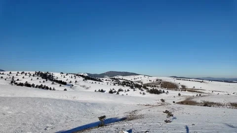 Snowy Hills Under Blue Sky Stock Footage 305088902