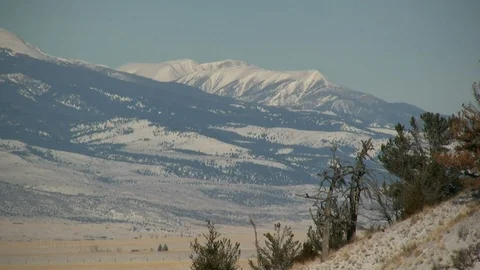 Snowy Hillside and Distant Mountains in Lee-Metcalf Wilderness Area Stock Footage 106729048