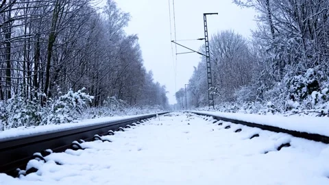 Snowy Jungle Scenery: Empty Railroad Tracks in Winter | 4K Footage. Stock Footage 235377199