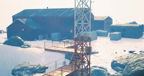 Snowy landscape featuring a communication tower near remote buildings Ilustración de archivo