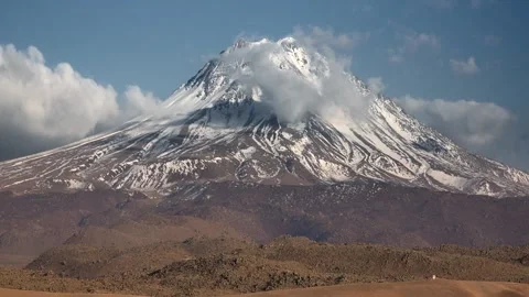 Snowy Mount Hasan volcano rises above Central Anatolia plains - Winter Mountain Stock Footage 339560651