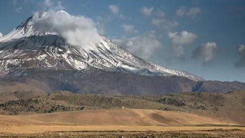 Snowy Mount Hasan volcano rises above Central Anatolia plains - Dramatic Winter Stock Footage 339560747