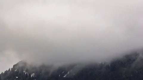 Snowy mountain and clouds moving fast in timelapse Stock Footage 84472914