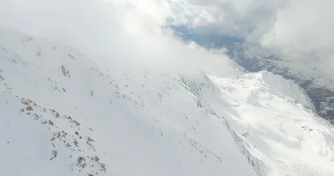 Snowy Mountain and Valley with Clouds Aerial View Stock Footage 118957498