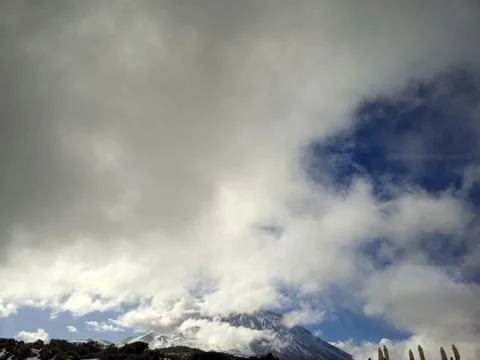 Snowy mountain beneath dramatic cloudy sky 스톡 사진