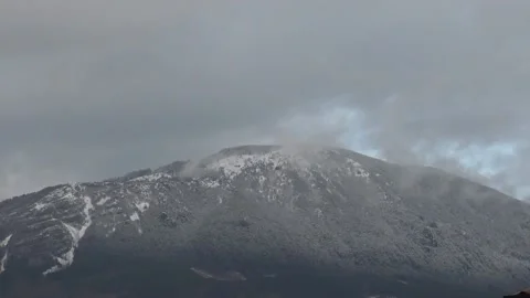 Snowy mountain with clouds timelapse Stock Footage 159075449