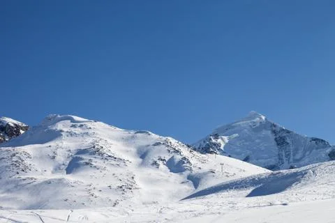 Snowy mountain with glacier and slope for freeriding with snow cornice Stock Photos