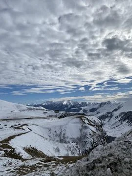 Snowy mountain landscape with cloudy sky, perfect background for winter or .. Stock Photos