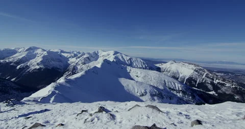 Snowy mountain landscape with low sun and blue sky. Video stock 147645089