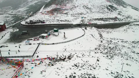 Snowy mountain pass road and visitor facilities at Sejila Stock-Footage 345879556