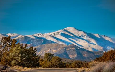 Snowy mountain peak and road in Nevada Stock Photos