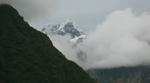 Snowy mountain peak with clouds rolling across Stock Footage 55539131