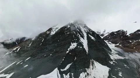 Snowy Mountain Peak Covered by Clouds Stock Footage 308989912