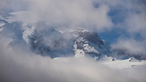 Snowy Mountain Peak Emerging Through Clouds Stock Footage 277181668