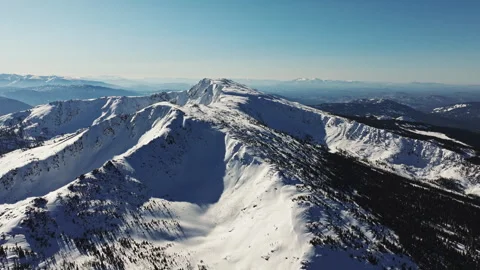 Snowy mountain peak under blue sky in winter Video stock 315073609