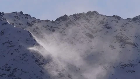 Snowy Mountain Peak with Wind Blown Powder Stock Footage 320853421