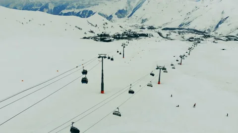 Snowy mountain peaks and a functioning cable tramway Video stock 104898802