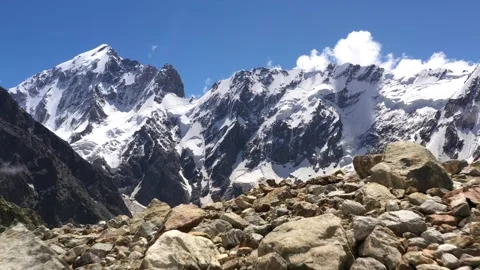 Snowy mountain peaks and sharp rocks. Scenic aerial landscape of high tops of Stock Footage 169749277