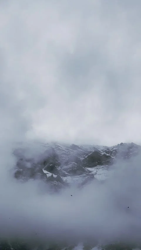 Snowy Mountain Peaks Emerging from Clouds. Stock Footage 328462272