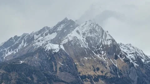 Snowy mountain peaks in gray clouds. distancing movement Hohe Tauern Stock Footage 239189825