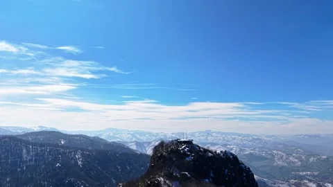 Snowy Mountain Peaks Under Blue Sky with Clouds Cinematic Aerial Drone 4K Vídeos de archivo 334547986