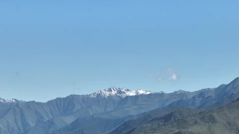 Snowy Mountain Range Above Layered Ridges in Sichuan, China Stock Footage 344034371