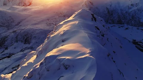 Snowy mountain range: cold sunset or sunrise, high peaks, golden hour, inspiring Stock Footage 268103865