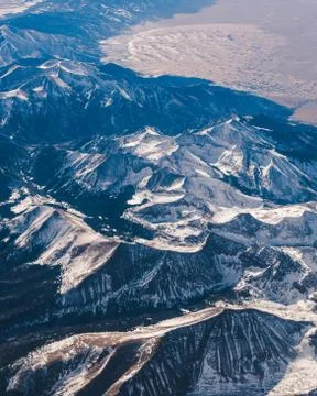 Snowy mountain range from plane Stock Photos