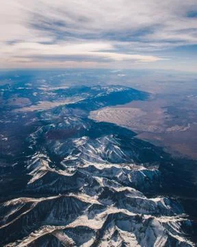 Snowy mountain range from plane Stock Photos