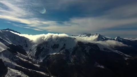 Snowy mountain range reflected in calm blue lake Stock Footage 340963097