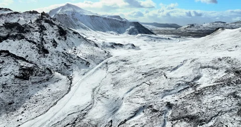 Snowy mountain range under blue sky in Iceland. Epic aerial winter landscape. Stock Footage 242069155