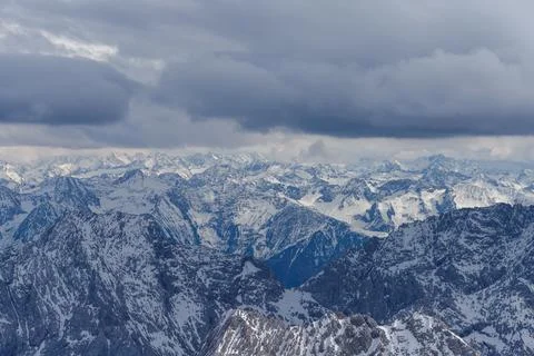 Snowy Mountain Range Under Cloud Cover Stock Photos