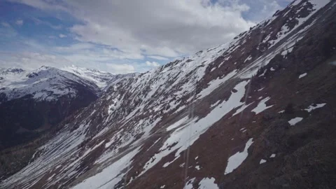 Snowy mountain range under cloudy sky Stock Footage 309989545