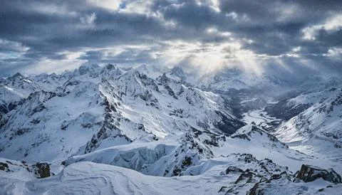 Snowy Mountain Range Under Cloudy Sky. Stock Illustration