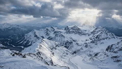 Snowy mountain range under cloudy sky. Stock Illustration