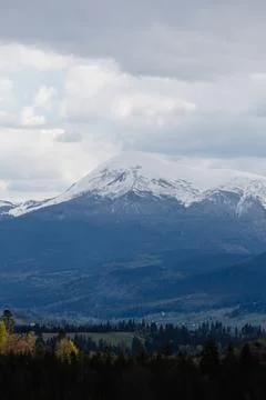 Snowy mountain range under cloudy sky Stock Photos