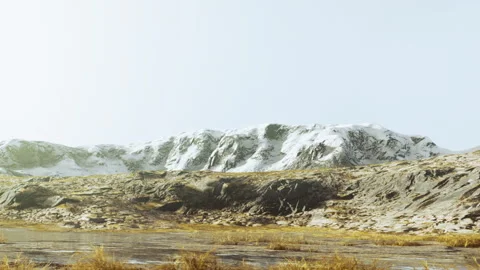 Snowy mountain range viewed from a grassy plain during daytime Stock Footage 340978567