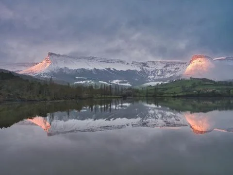 Snowy Mountain Reflection at Twilight - Dramatic winter landscape featuring.. Stock Photos
