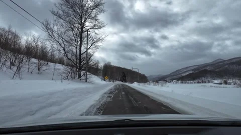 Snowy Mountain Road with Light Snowfall Hokkaido Winter Stock Footage 333369432