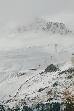 Snowy mountain ski resort with ski lifts running Stock Photos
