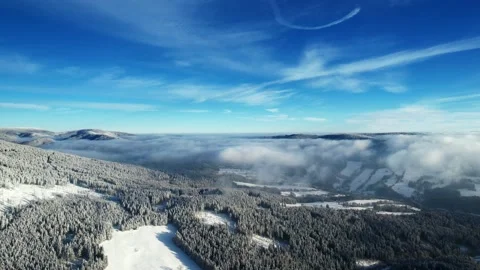 Snowy mountain with ski slope, trees and beautiful sky in winter Stock Footage 226366647