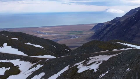 Snowy Mountain Slopes and Coastal Plains with Rivers in Hoffellsfjoll, Iceland Stock Footage 339765621