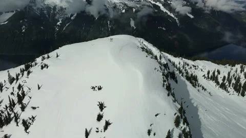 Snowy Mountain Summit on a cloudy day, Aerial Drone View Stock Footage 169558517