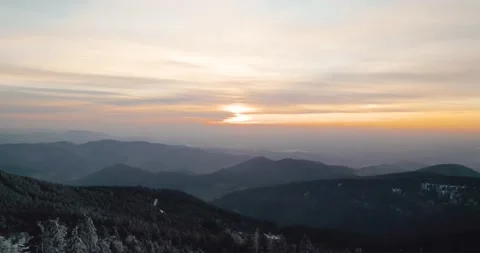 Snowy mountain at sunset drone forest trees in germany Stock Footage 170440530