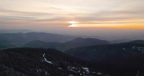 Snowy mountain at sunset drone forest trees in germany Stock Footage 170440590