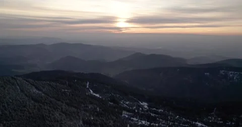 Snowy mountain at sunset drone forest trees in germany Stock Footage 170440604