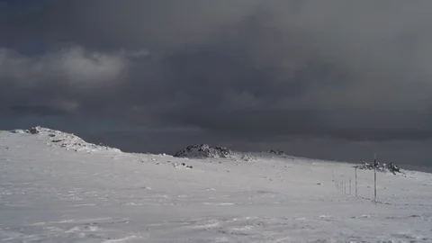 Snowy Mountain Top with Dark Clouds 4K Stock Footage 76517337