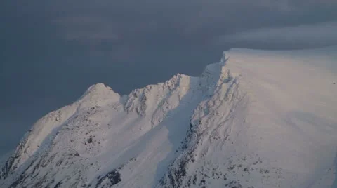 Snowy mountain top in sunset Stock Footage 12135859
